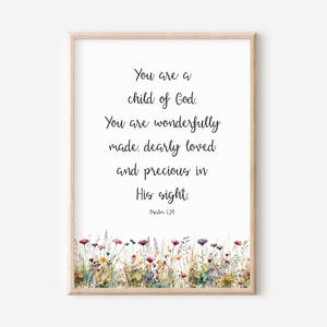 May include: Framed print with the text "You are a child of God. You are wonderfully made, dearly loved and precious in His sight." Floral watercolor design at the bottom. Psalm 139.
