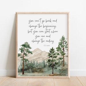 May include: A watercolor print with a quote by C.S. Lewis: "You can't go back and change the beginning, but you can start where you are and change the ending." The quote is set against a backdrop of a mountain range and forest.