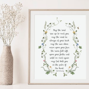 May include: A white printable art print with a floral border and a poem that reads: "May the road rise up to meet you. May the wind be always at your back. May the sun shine warm upon your face. The rains fall soft upon your fields, and until we meet again may God hold you in the palm of His hand. Irish Blessing"