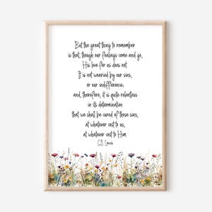 May include: A framed print with a quote by C.S. Lewis, presented in a stylish script. The text is on a white backdrop, with a watercolour floral border at the base. The frame is a light wood colour, giving the artwork a warm feel.