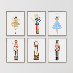 May include: Set of six framed watercolor prints featuring characters from The Nutcracker ballet. The prints include a ballerina, a mouse king, a ballerina in blue, a nutcracker soldier, a grandfather clock, and a second nutcracker soldier.