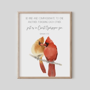 May include: A framed print featuring a watercolor painting of two cardinals perched on a branch. The male cardinal is red, and the female is tan. The print includes the text "BE KIND AND COMPASSIONATE TO ONE ANOTHER, FORGIVING EACH OTHER, just as in Christ God forgave you."