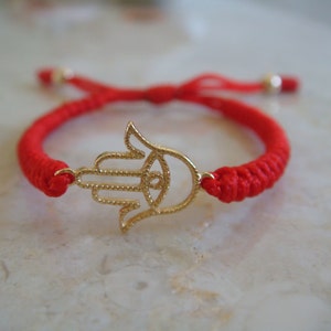 Nueva pulsera para bebé ajustable de cuentas hamsa chapadas in oro.