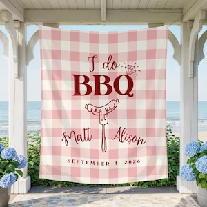 May include: A rectangular fabric banner featuring a light pink and white gingham pattern. The text reads I do BBQ with a diamond icon, followed by the names Matt and Alison, and the date September 4, 2026, in dark red lettering.