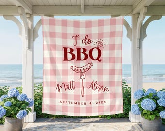 May include: A rectangular fabric banner featuring a light pink and white gingham pattern. The text reads I do BBQ with a diamond icon, followed by the names Matt and Alison, and the date September 4, 2026, in dark red lettering.