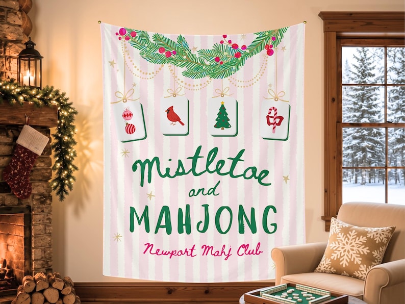 May include: A rectangular wall tapestry featuring a light pink and white vertical striped background. It displays a green pine garland with red berries, four hanging mahjong tiles with holiday icons, and the text Mistletoe and MAHJONG Newport Mahj Club.