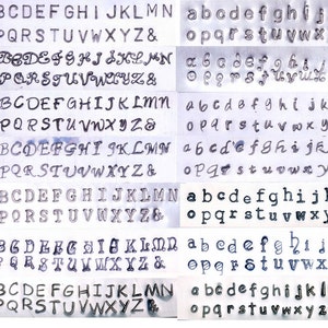 May include: A sheet of metal with seven rows of stamped alphabet letters in uppercase and lowercase fonts. Each row displays a different font style, including serif and sans-serif options, and the ampersand symbol.