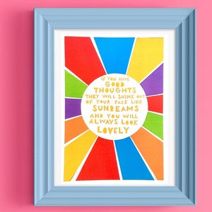 May include: A framed print with a rainbow sunburst design and the text "If you have good thoughts they will shine out of your face like sunbeams and you will always look lovely."