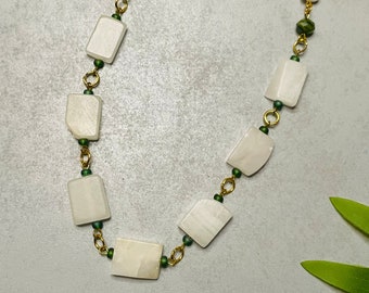 White Stone Necklace with Green Accents and Gold Tone Chain