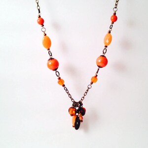 Orange and bronze fall toned charm statement necklace