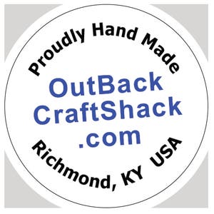 May include: White circle sticker with the text "Proudly Hand Made" in black text around the outside edge. The text "OutBack CraftShack .com Richmond, KY USA" is in blue text in the center of the sticker.