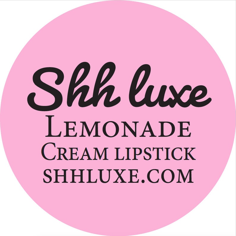 May include: Pink circle with black text that reads "Shh luxe LEMONADE CREAM LIPSTICK SHHLUXE.COM"