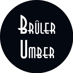 May include: Black and white logo with the text "BRÜLER UMBER" in a stylized font.
