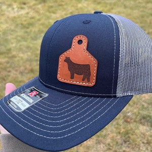 Show Heifer Richardson Trucker Hat with Engraved Leather Ear Tag Patch