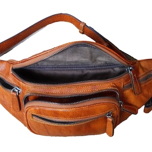 Tan leather fanny bag with two zippers, combining practicality and fashion in one accessory