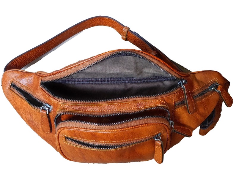 Tan leather fanny bag with two zippers, combining practicality and fashion in one accessory