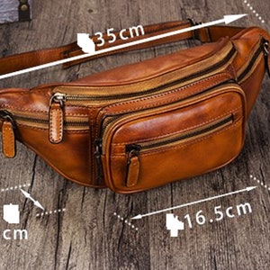 May include: A brown leather fanny pack with multiple zippered compartments. The pack measures 35 inches in length, 13 inches in height, and 16.5 inches in width.