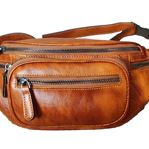 Tan leather fanny bag featuring two zippers for secure storage and stylish convenience
