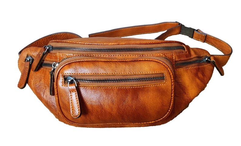 Tan leather fanny bag featuring two zippers for secure storage and stylish convenience