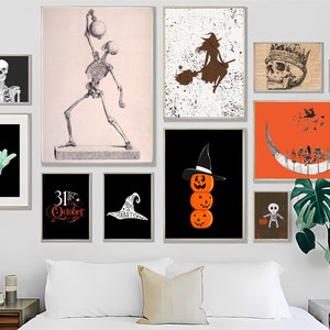 May include: A gallery wall featuring various Halloween-themed art prints. The collection includes a skeleton, a witch on a broom, a skull with a crown, and stacked jack-o'-lanterns. The color palette includes black, orange, white, and brown.