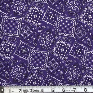 May include: Purple fabric with a white bandana print. The fabric is patterned with various sizes of squares and paisley shapes.