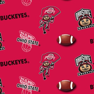 May include: A vibrant red fabric pattern featuring the Ohio State Buckeyes logo, the mascot Brutus Buckeye holding a flag, brown footballs, and white line-art basketball hoops. The text BUCKEYES and OHIO STATE is repeated throughout the design.