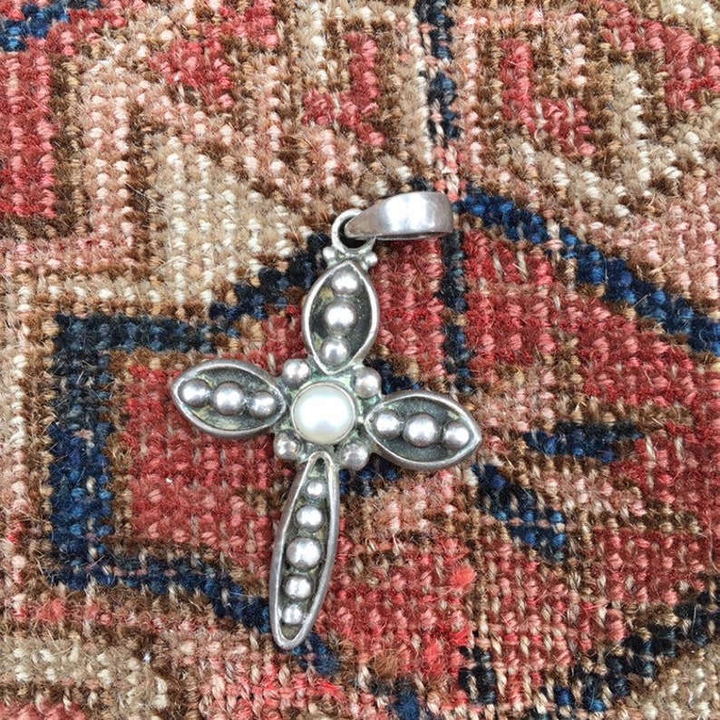 Sterling silver cross pendant with pearl center