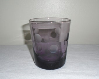 May include: A purple glass tumbler with a frosted polka dot pattern.