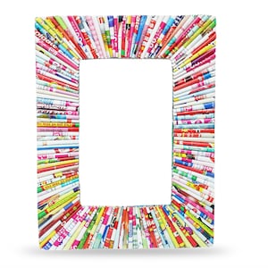 May include: A colorful picture frame made from rolled up magazine pages. The frame is rectangular and has a white background.