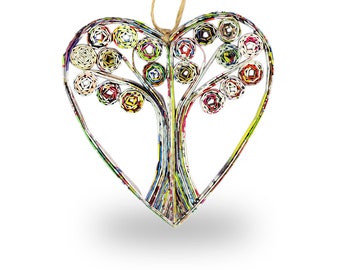 May include: A heart-shaped paper craft with a tree design made from rolled up colorful paper. The tree has a thick trunk and branches with leaves made from rolled paper.