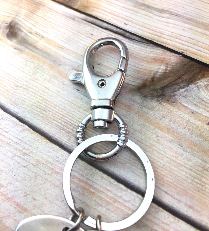 May include: Silver key chain with a large ring and a lobster clasp.