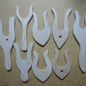May include: Eight wooden knitting needles with a unique flame-shaped design. The needles have a hole in the center of the top and bottom of the flame shape.