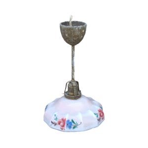 May include: Vintage ceiling light fixture with a white, scalloped glass shade adorned with red, blue, and pink floral designs. The fixture has a brass-colored top and a metal rod.