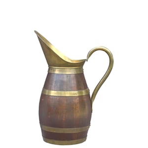 May include: A vintage pitcher with a wooden body and brass accents. The pitcher has a curved handle and a spout. Brass bands encircle the wooden body. The pitcher is likely used for serving water or other beverages.