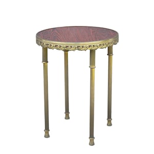 May include: A small, round side table with a dark reddish-brown tabletop and ornate gold-coloured trim. The table has four slender, gold-coloured legs. The table is approximately 61 cm tall.