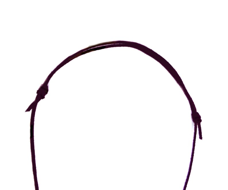 May include: A dark purple cord necklace with a knot at each end.