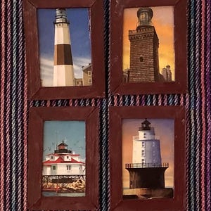 May include: Four framed lighthouse paintings. Each painting depicts a different lighthouse with varying designs and colors. The frames are a dark brown color. The backgrounds of the paintings include blue skies, water, and buildings.