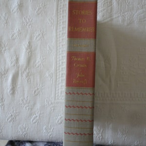 May include: A red hardcover book titled "Stories to Remember" with the authors' names Thomas B. Costain and John Beecroft listed below the title.