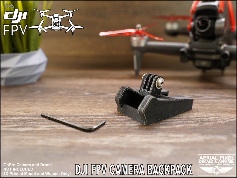 May include: A black 3D printed GoPro camera mount for a DJI FPV drone. The mount is designed to attach to the drone's camera backpack. The text "DJI FPV CAMERA BACKPACK" is visible in the image.