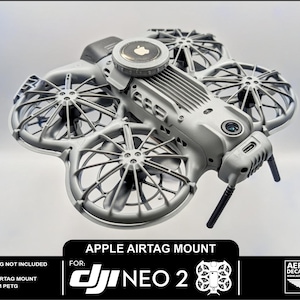 May include: A gray Apple AirTag mount for a DJI Neo 2 drone. The mount features four propellers and a central housing for the AirTag. The image includes text that reads "Apple AirTag Mount" and "DJI Neo 2".