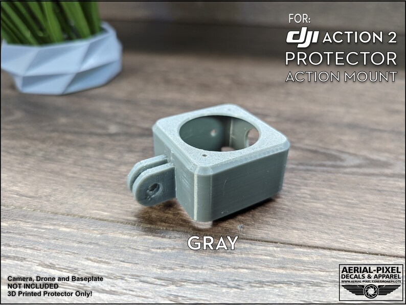 May include: Gray 3D printed protector for a DJI Action 2 camera. The protector has a GoPro-style mount.