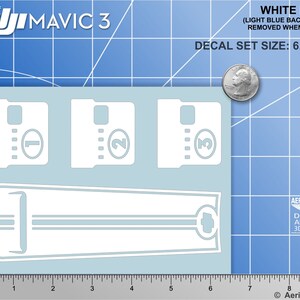 May include: White decal set for a DJI Mavic 3 drone. The set includes three numbered decals, a decal with two stripes, and a decal with a small circle. The decals are 6 inches by 4.25 inches.