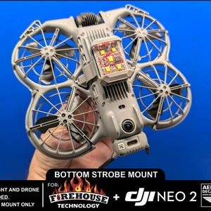 May include: A grey drone accessory with multiple propellers and a central compartment with red and yellow lights. The text "BOTTOM STROBE MOUNT" is visible, along with the logos for Firehouse Technology and DJI NEO 2. The background is blue.