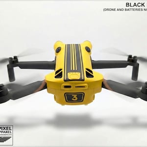 May include: A yellow drone with black detailing and propellers. The drone features black decals and the number 3. The text "BLACK DECALS (DRONE AND BATTERIES NOT INCLUDED)" is at the top. The Aerial-Pixel Decals & Apparel logo is at the bottom.