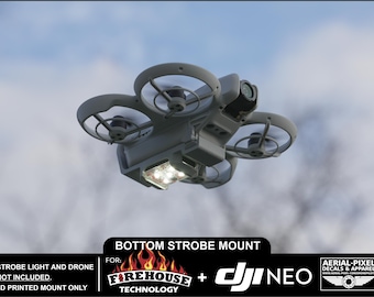 May include: A gray drone with four propellers and a camera, flying against a blurred sky. The drone has a bottom strobe mount with the text "BOTTOM STROBE MOUNT" and "FIREHOUSE TECHNOLOGY + DJI NEO". The text "STROBE LIGHT AND DRONE NOT INCLUDED. 3D PRINTED MOUNT ONLY" is also visible.