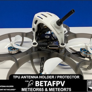 May include: White TPU antenna holder and protector for BetaFPV Meteor65 and Meteor75 drones. The holder is 3D printed and includes two antenna holders.