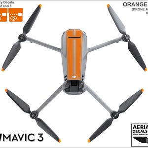 May include: Orange and gray drone with decals. The drone has four propellers and a camera. The decals are numbered 1, 2, and 3. The text "FOR: DJI MAVIC 3" is in the lower left corner. The text "ORANGE DECALS (DRONE AND BATTERIES NOT INCLUDED)" is in the upper right corner. The text "AERIAL-PIXEL DECALS & APPAREL www.AERIAL-PIXEL.COM/DRONEPILOTS" is in the lower right corner.