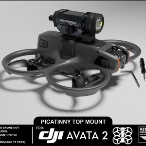 May include: Black drone with a mounted flashlight. The drone has four propellers and a camera. The image includes a Picatinny top mount for DJI Avata 2, along with tools and the Aerial Pixel Decals & Apparel logo.