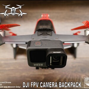 May include: A 3D printed mount for a GoPro camera to be attached to a DJI FPV drone. The text "DJI FPV CAMERA BACKPACK" is printed below the drone. The text "GoPro Camera and Drone NOT INCLUDED 3D Printed Mount and Wrench Only!" is printed below the image.