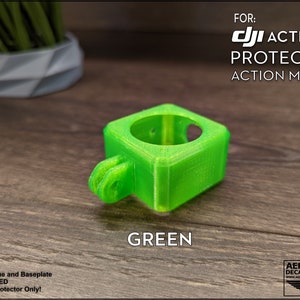 May include: Green 3D printed protector for a DJI Action 2 camera. The protector is designed to fit the camera's action mount. Camera, drone, and baseplate are not included.
